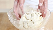 Pastry for buttermilk biscuits being kneaded by hand