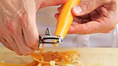 A carrot being peeled