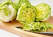 Iceberg lettuce, partly sliced into strips