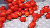 Teardrop tomatoes being tipped onto a table