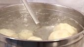 Dumplings being boiled in water