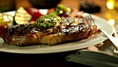 A grilled steak with melting herb butter
