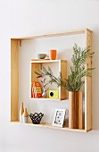 Different sized wooden frames as a pretty wall shelf