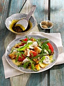 Bread salad with rocket, tomatoes and mozzarella