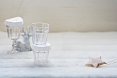 A winter arrangement of glasses, a reindeer figure and a decorative star