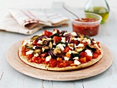 A tomato salsa and vegetable pizza