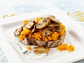 Toast topped with pumpkin and mushrooms