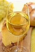 A glass of white wine with cheese