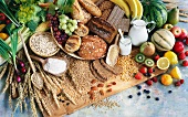 An arrangement of corn, bread, milk, fruit and vegetables