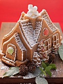 A gingerbread house with the baking tin in the background