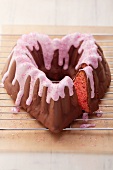 A heart-shaped cherry cake with chocolate glaze and icing