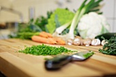 Chopped parsley and vegetables on a chopping board