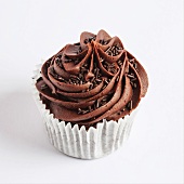 A chocolate cupcake on a white surface