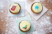 Cupcakes decorated with light frosting and marzipan decorations