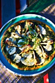 A rocket, artichoke and mozzarella pizza