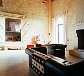Interior with sofa set & open fireplace in Château Maignaut (Pyrenees, France)