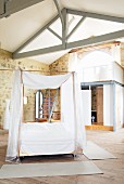 Bedroom with four-poster bed on castors & bathroom block in Château Maignaut (Pyrenees, France)