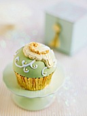 A cupcake decorated with green icing