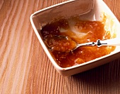 Peach and malt beer preserve in a dish with a spoon
