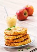 A stack of potato cakes with apple sauce