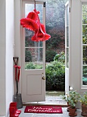 Red decorative bells of honeycomb paper hanging on door