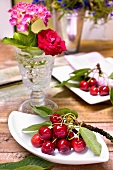Sprigs of cherries on white plates