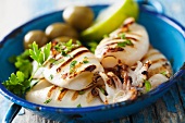 Grilled squid with parsley, lemons and olive