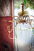 Chandelier with strings of glass beads in craft shop