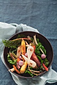 Root vegetables on a bed of chard