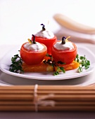 Tomatoes filled with a yoghurt cream on persimmon slices