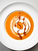 Carrot soup with cream and caramel (seen from above)