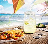 Margarita Pouring Over Ice in a Jar; Shrimp Taco; By the Beach with Money on the Table