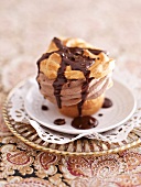 A mocha cupcake with chocolate sauce
