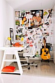 Many photographs on pinboard in small office