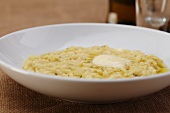 Butter Melting on Risotto in a White Bowl