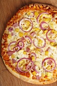 Whole Hawaiian Pizza with Pineapple, Canadian Bacon and Red Onions; From Above