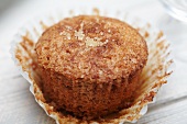 A Cinnamon Sugar Muffin with Wrapper Peeled Away