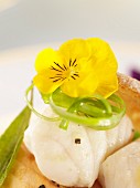 Steamed fish fillet with an edible flower