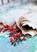 Sprays of red bean flowers wrapped in newspaper