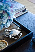 Silver crab on a wooden tray