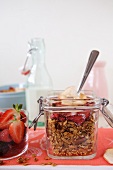 A Canister of Homemade Granola; Open with a Spoon