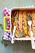 Baking Dish of Potato Gratin Made with Assorted Potatoes; Spoon and Fork; From Above