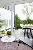 White side table and black bench in front of terrace door