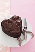 A heart-shaped chocolate cake with chocolate icing