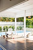 Roofed veranda with view of swimming pool