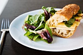 Apple and Cheddar Cheese Sandwich on a Baguette with Spinach; Side Salad