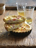 Halved Mini Quiche Lorraine Stacked on Whole Mini Quiche Lorraine