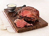 Roast beef, sliced, on a chopping board