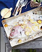 Snapper in a salt crust with slices of lemon