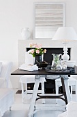 Black and white furnishings - tray of refreshing drinks and table lamp with white lampshade on dark tabletop